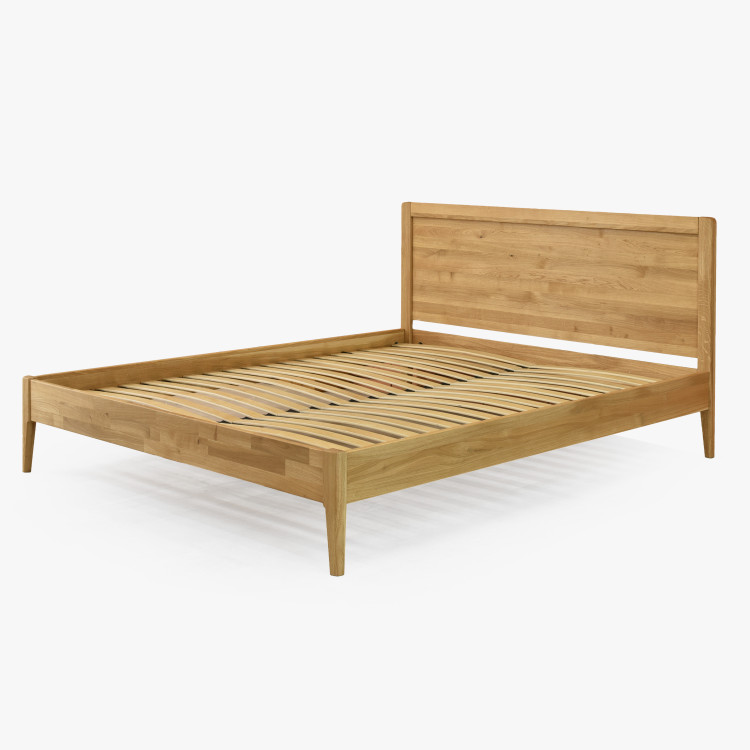 Manželská postel na nohou z dubu model Praha